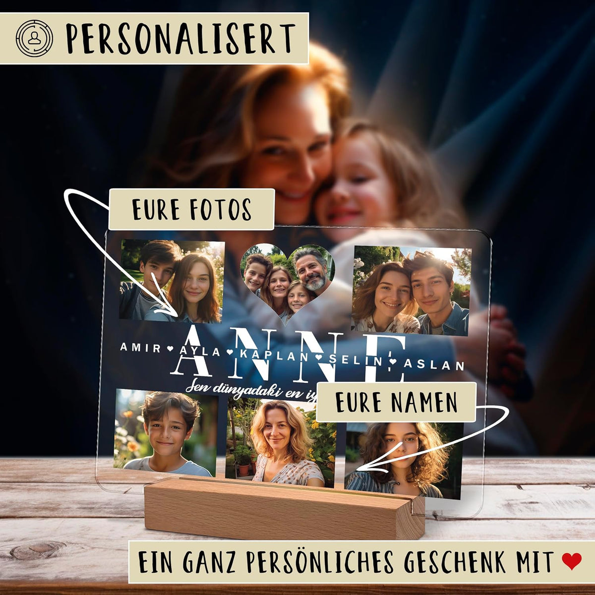 Personalisierte Acryl-Fototafel auf einer hölzernen LED-Basis, die mehrere Familienfotos und den großen Text „ANNE“ mit den Namen „Amir, Ayla, Kaplan, Selin, Aslan“ zeigt. Deutsche Beschriftungen weisen auf anpassbare Fotos und Namen hin. Der Text unten lautet „Ein ganz persönliches Geschenk mit“ mit einem Herz.