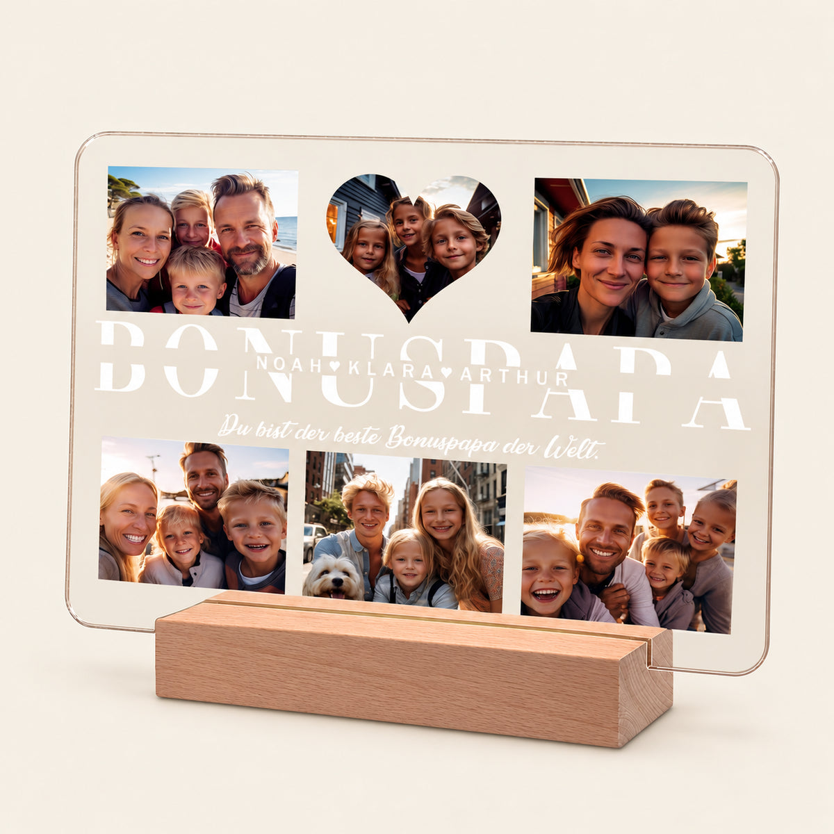 Personalisierte Acryl‑LED‑Fotodrehscheibe auf einem Holzsockel, zeigt fünf Familienfotos und einen herzförmigen Ausschnitt. Großer Text lautet 'BONUSPAPA' mit den Namen 'Noah, Klara, Arthur' und dem deutschen Text 'Du bist der beste Bonuspapa der Welt.'